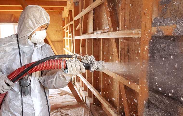 a tech doing an insulation application